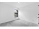 A bright bedroom features plush gray carpeting and a window with a view at 4743 Michaler St, North Port, FL 34286