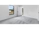 A bright bedroom features plush gray carpeting and a large window with an outside view at 4743 Michaler St, North Port, FL 34286
