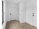 Inviting foyer with wood-look tile flooring, white doors, and neutral decor at 4743 Michaler St, North Port, FL 34286