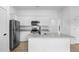Modern kitchen with white cabinets, stainless steel appliances, and granite countertops at 4743 Michaler St, North Port, FL 34286