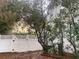 Backyard area featuring a privacy fence, mature trees, and ample space for outdoor activities at 6919 Greenhill Pl, Tampa, FL 33617
