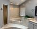 Bathroom featuring a large garden tub, separate shower, and gray paint at 6919 Greenhill Pl, Tampa, FL 33617