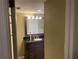Bathroom with granite vanity, wood cabinets, and decorative lighting at 6919 Greenhill Pl, Tampa, FL 33617