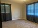 This carpeted bedroom has neutral walls, large windows and is a blank canvas for your personal touch at 6919 Greenhill Pl, Tampa, FL 33617