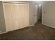 Bedroom with carpet, and a closet with paneled doors at 6919 Greenhill Pl, Tampa, FL 33617