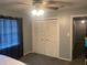 Bedroom with carpet, ceiling fan, closet, and black-out curtains at 6919 Greenhill Pl, Tampa, FL 33617