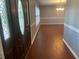 Inviting foyer with wood-look floors, decorative front door, and bright light at 6919 Greenhill Pl, Tampa, FL 33617