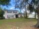 Charming two-story home with red shutters, a well-maintained lawn and beautiful, mature shade trees at 6919 Greenhill Pl, Tampa, FL 33617