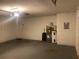 Spacious garage with door to the house and a water heater on the side at 6919 Greenhill Pl, Tampa, FL 33617