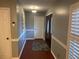 Inviting hallway with hardwood floors, and neutral wall paint creating a seamless flow at 6919 Greenhill Pl, Tampa, FL 33617