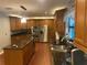 Modern kitchen with custom cabinets, granite countertops, stainless appliances, and hardwood style flooring throughout at 6919 Greenhill Pl, Tampa, FL 33617