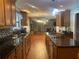 The gourmet kitchen features granite countertops and a mosaic backsplash and has views of the living room at 6919 Greenhill Pl, Tampa, FL 33617