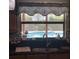 Kitchen sink with a view of the backyard swimming pool through the window at 6919 Greenhill Pl, Tampa, FL 33617