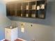 Functional laundry room with storage cabinets, utility sink, and tile flooring at 6919 Greenhill Pl, Tampa, FL 33617