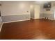Living room featuring wood-look flooring, two-tone paint and mounted television at 6919 Greenhill Pl, Tampa, FL 33617