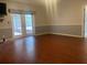 Spacious living room with wood-look tile floors and glass doors to the outside at 6919 Greenhill Pl, Tampa, FL 33617
