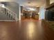 The open floor plan connects the living room to the kitchen, featuring hardwood-style floors and stairs to the upper level at 6919 Greenhill Pl, Tampa, FL 33617