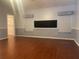 Open living room with wood floors and plenty of space with access to pantry at 6919 Greenhill Pl, Tampa, FL 33617