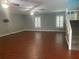 Bright living room features hard wood floors, plenty of space and a classic stairway at 6919 Greenhill Pl, Tampa, FL 33617