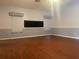 Living room with tile floors, decorative window treatments, and a large mounted television at 6919 Greenhill Pl, Tampa, FL 33617