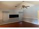 Bright living room with wood-look floors, ceiling fan, and decorative window treatments at 6919 Greenhill Pl, Tampa, FL 33617