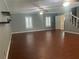 Expansive living room with hardwood floors, bright windows, and easy access to stairway at 6919 Greenhill Pl, Tampa, FL 33617