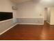 Living room offering tile floors, wainscoting, and large wall-mounted television at 6919 Greenhill Pl, Tampa, FL 33617