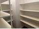 Spacious walk-in pantry featuring open shelving for effortless organization and storage at 6919 Greenhill Pl, Tampa, FL 33617