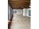 View of a large sunroom with stained concrete, white walls, and access to the backyard at 6919 Greenhill Pl, Tampa, FL 33617