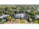 Charming home featuring a metal roof, a front porch, and a brick driveway, all surrounded by lush trees at 7312 7Th Nw Ave, Bradenton, FL 34209