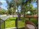 Spacious backyard with a well-manicured lawn, privacy fence, and mature trees providing ample shade at 1046 Bass Blvd, Dunedin, FL 34698