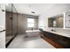 Spa-like bathroom with a freestanding tub, glass-enclosed shower, modern fixtures, and elegant tile work at 1046 Bass Blvd, Dunedin, FL 34698