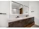 Modern bathroom vanity with double sinks, marble countertops, sleek hardware, and backlit mirrors for a touch of luxury at 1046 Bass Blvd, Dunedin, FL 34698