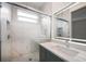 Stylish bathroom features a marble tile shower, hexagon tile floor, and modern illuminated mirror at 1046 Bass Blvd, Dunedin, FL 34698