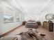 Bright bedroom featuring large windows, hardwood floors, ample natural light, and stylish decor elements at 1046 Bass Blvd, Dunedin, FL 34698