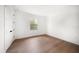 Bright bedroom with hardwood floors, a window, and white walls offers a clean, modern aesthetic at 1046 Bass Blvd, Dunedin, FL 34698