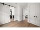 Bright hallway featuring modern doors, light hardwood floors, and easy access to various rooms and a half-bathroom at 1046 Bass Blvd, Dunedin, FL 34698