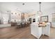 Open-concept kitchen with island and sleek appliances flowing into dining area at 1046 Bass Blvd, Dunedin, FL 34698