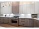 Bright kitchen featuring stainless steel gas range, quartz countertops, and custom cabinets at 1046 Bass Blvd, Dunedin, FL 34698