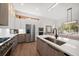 Modern kitchen features an island, gas range stove, built in oven, and stainless steel refrigerator at 1046 Bass Blvd, Dunedin, FL 34698