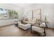 Cozy living room with bright, neutral furniture and light wood floors at 1046 Bass Blvd, Dunedin, FL 34698
