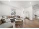 Inviting living room with a large sectional sofa, modern coffee table, and hardwood floors at 1046 Bass Blvd, Dunedin, FL 34698