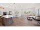 Open-concept living space features a modern kitchen with an island, a dining area, and a seating area at 1046 Bass Blvd, Dunedin, FL 34698