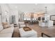 Open-concept living and dining area with light wood floors and bright, neutral furniture at 1046 Bass Blvd, Dunedin, FL 34698