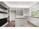 Organized walk-in closet featuring custom shelving, drawers, and ample storage space for clothing and accessories at 1046 Bass Blvd, Dunedin, FL 34698