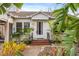 Charming home featuring a brick entryway and lush tropical landscaping adding curb appeal at 17 Venetian Ct, Tarpon Springs, FL 34689