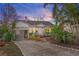 Charming single-story home with lush tropical landscaping, covered carport, and a welcoming facade at 17 Venetian Ct, Tarpon Springs, FL 34689
