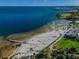 Expansive aerial view of a sandy beach with clear blue waters, palm trees and well-maintained park at 216 21St Ne Ave, St Petersburg, FL 33704