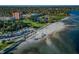 Scenic aerial view showcasing the sandy beach, lush green spaces, and surrounding buildings by the ocean at 216 21St Ne Ave, St Petersburg, FL 33704