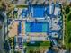 High-angle aerial view of multiple pools in a recreational facility, with a backdrop of lush greenery and sunny skies at 216 21St Ne Ave, St Petersburg, FL 33704